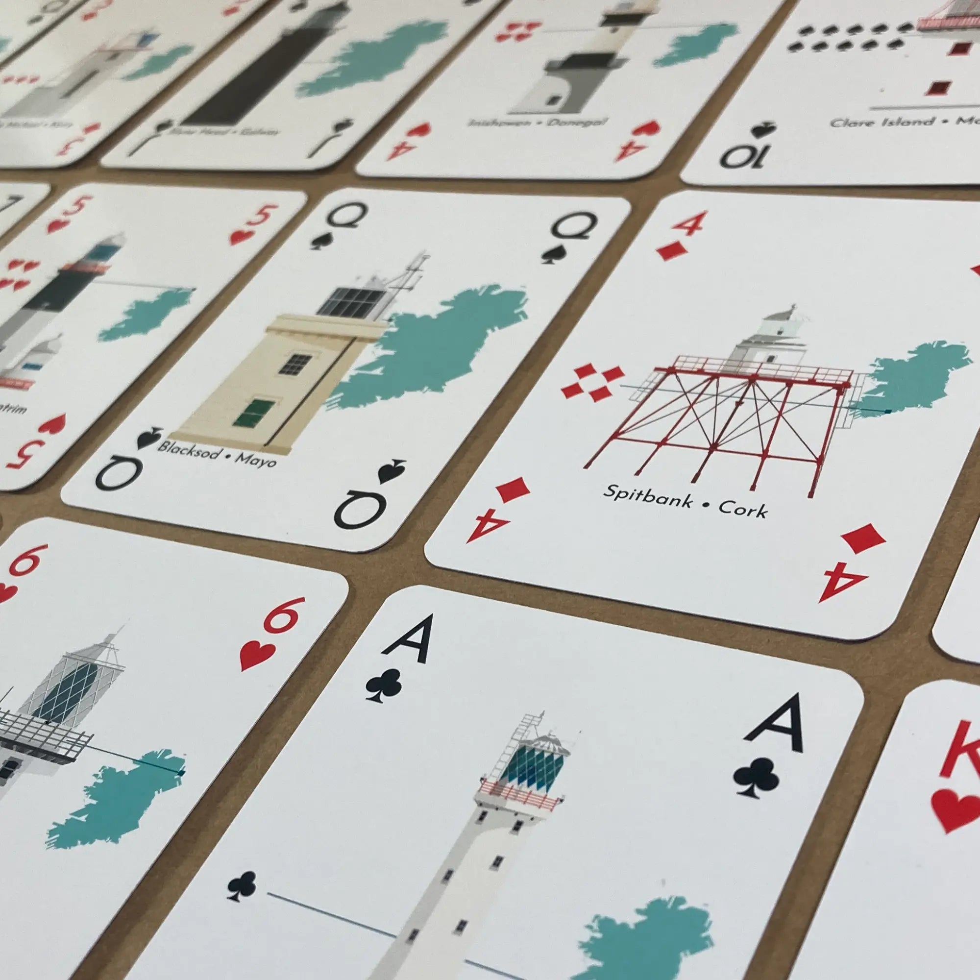 Lighthouses of Ireland playing cards with  illustrations on a table