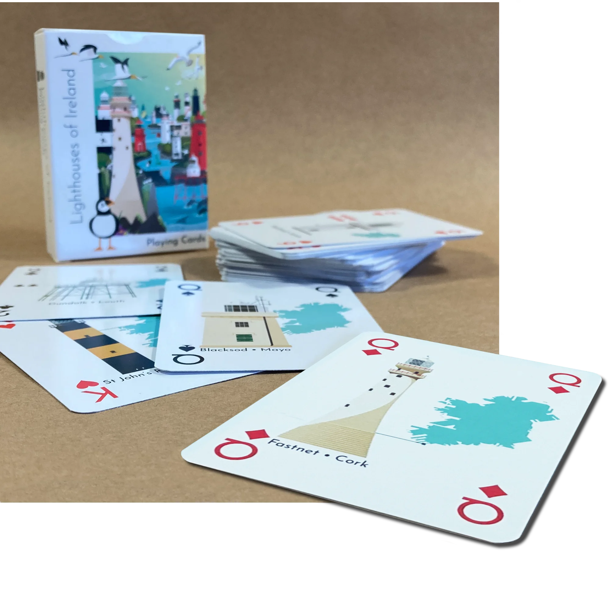 Playing cards with lighthouse designs on a brown surface