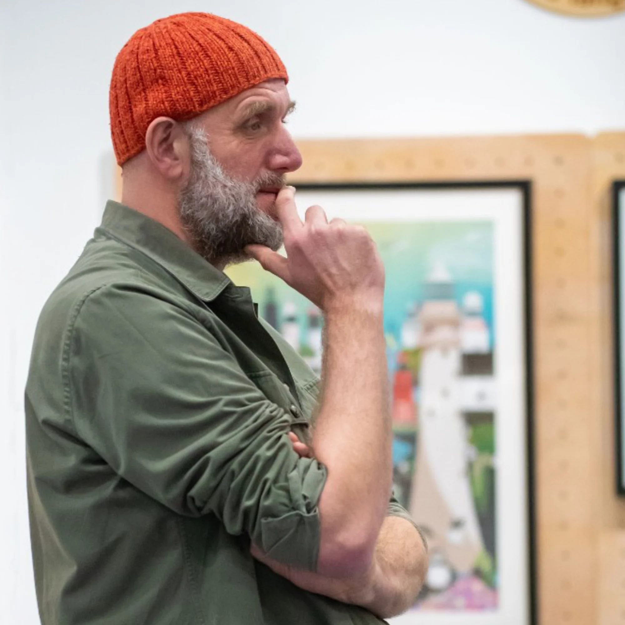 Bert wearing an orange beanie and green shirt