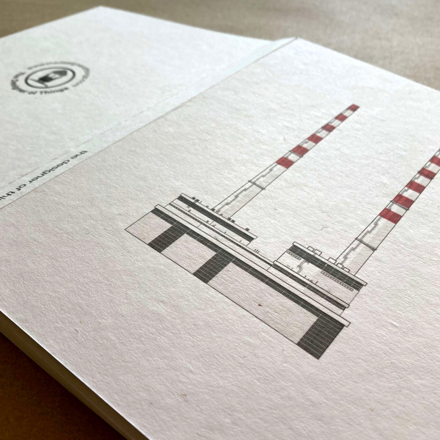 Folded open A5 notebook with Poolbeg Chimneys printed on the cover.